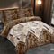 Patterned bedspread set on a bed in a bedroom with decorative pillows.