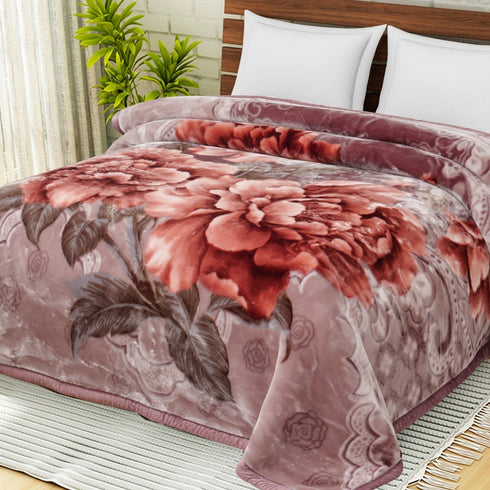 A double bed blanket with a floral pattern in red, purple, and white colors, displayed on a bed.