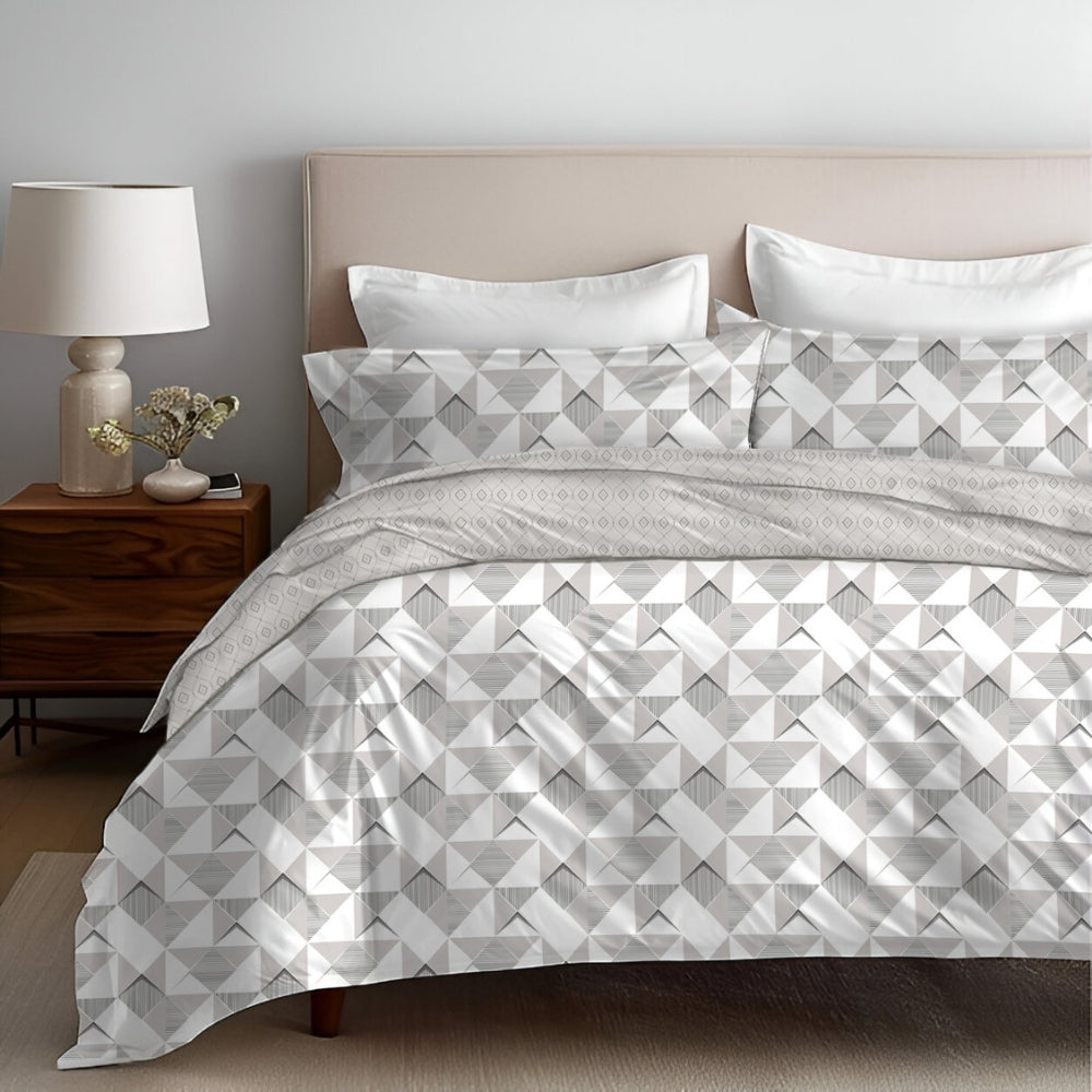 A bed with a comforter set featuring a geometric pattern, including a duvet cover, bedsheet, and pillowcases.