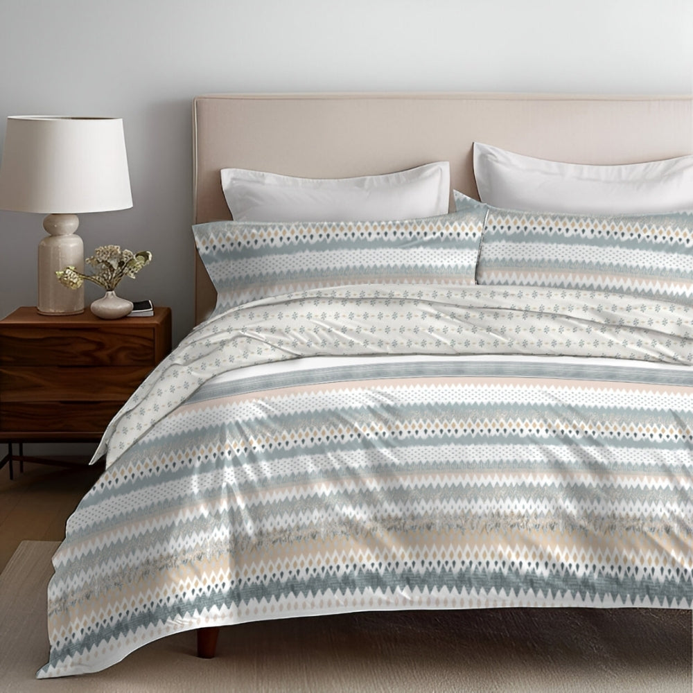 A 4 piece bedding set displayed on a bed, with a comforter, bedsheet, and two pillow covers, in a room setting.