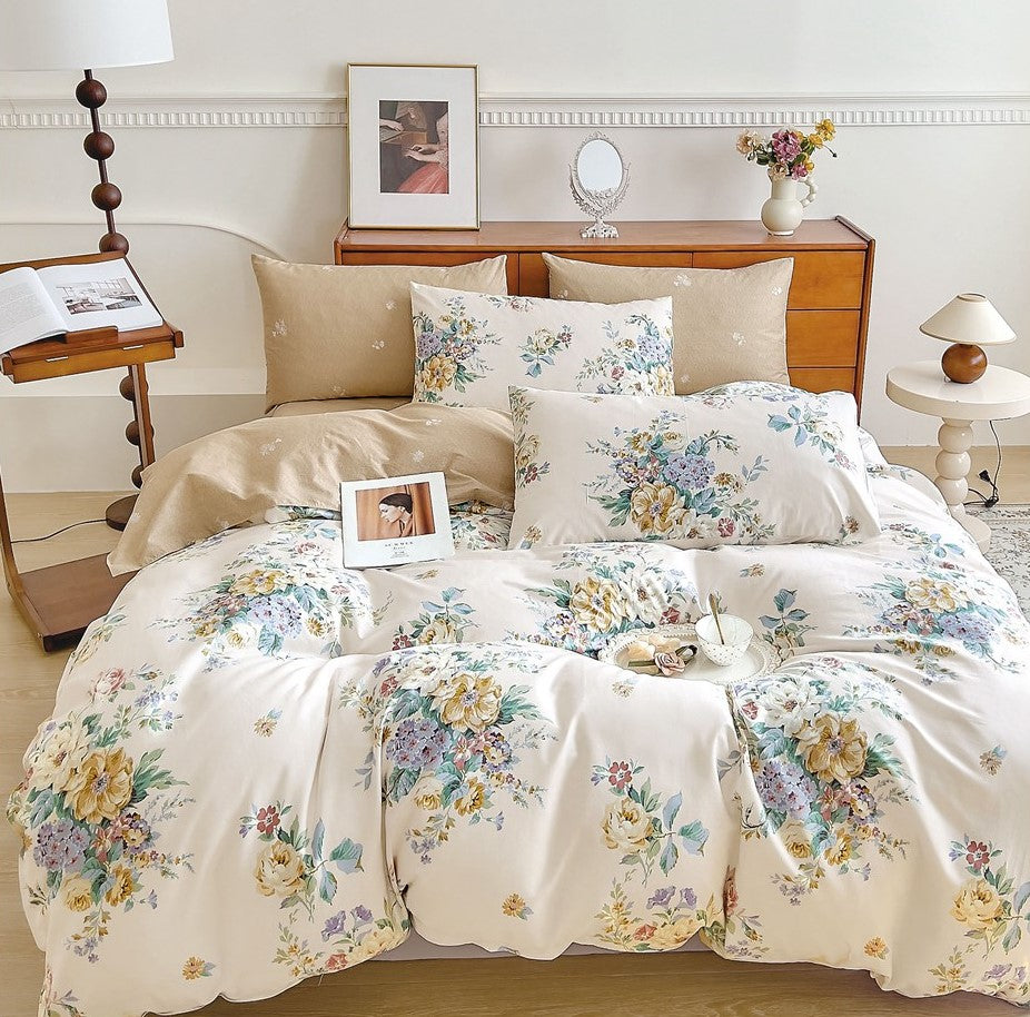 A king size bed sheet set with floral print, including two pillow covers, displayed on a bed in a bedroom setting.