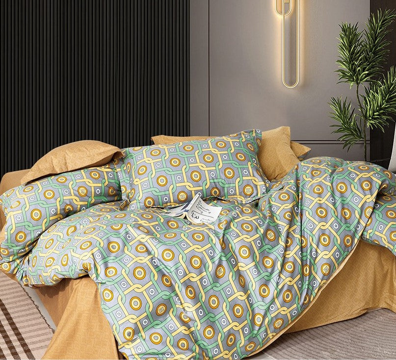 A king-size bed with a printed bed sheet set and two pillow covers, in a room with a minimalist decor.